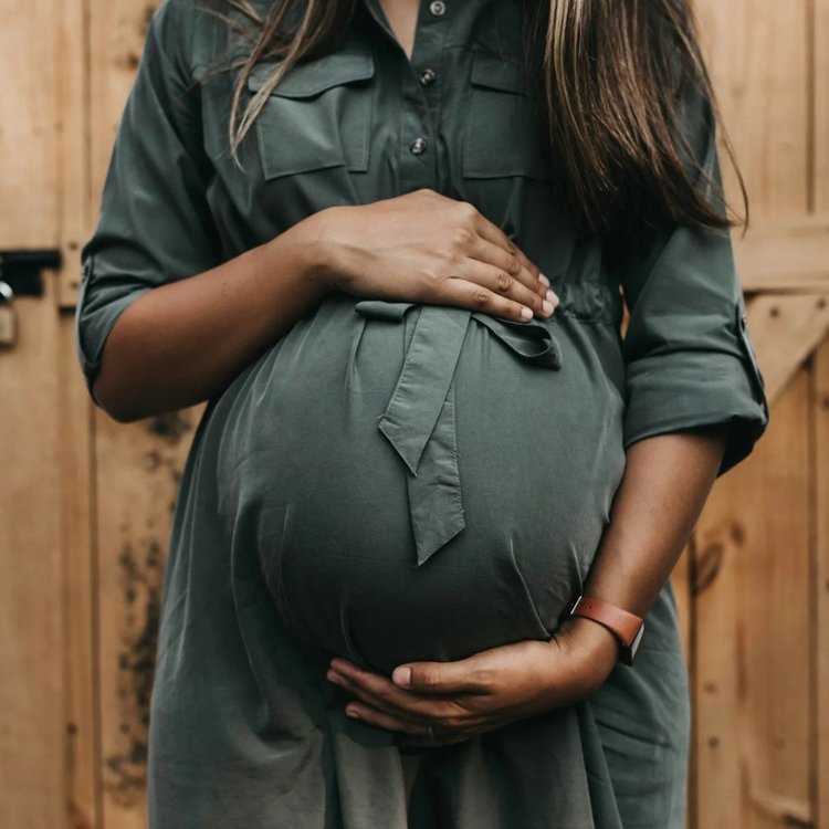 Expecting mother holding her belly